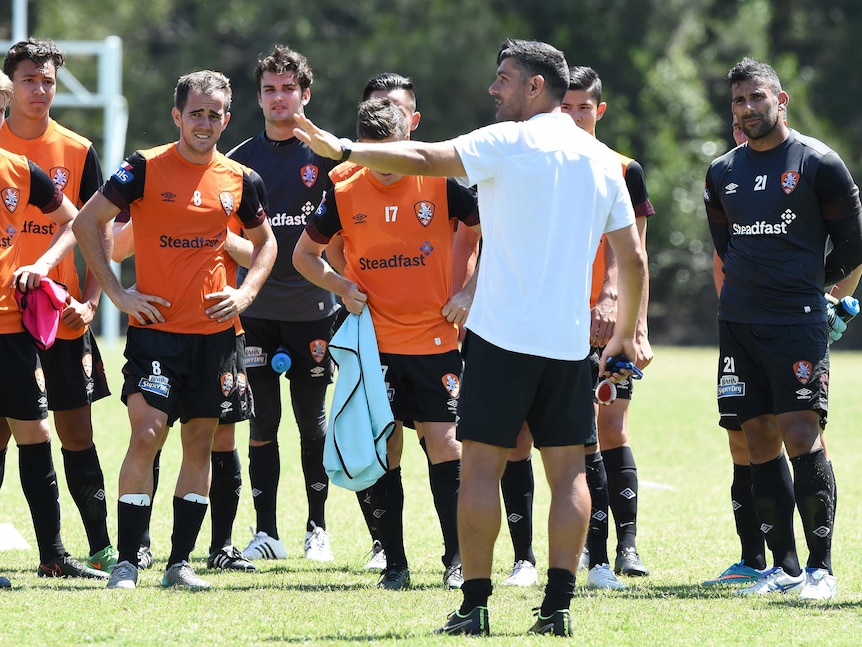 Brisbane Roar coach John Aloisi addresses players at training
