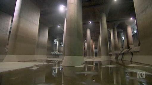 Water lays on the ground in an underground tunnel structure