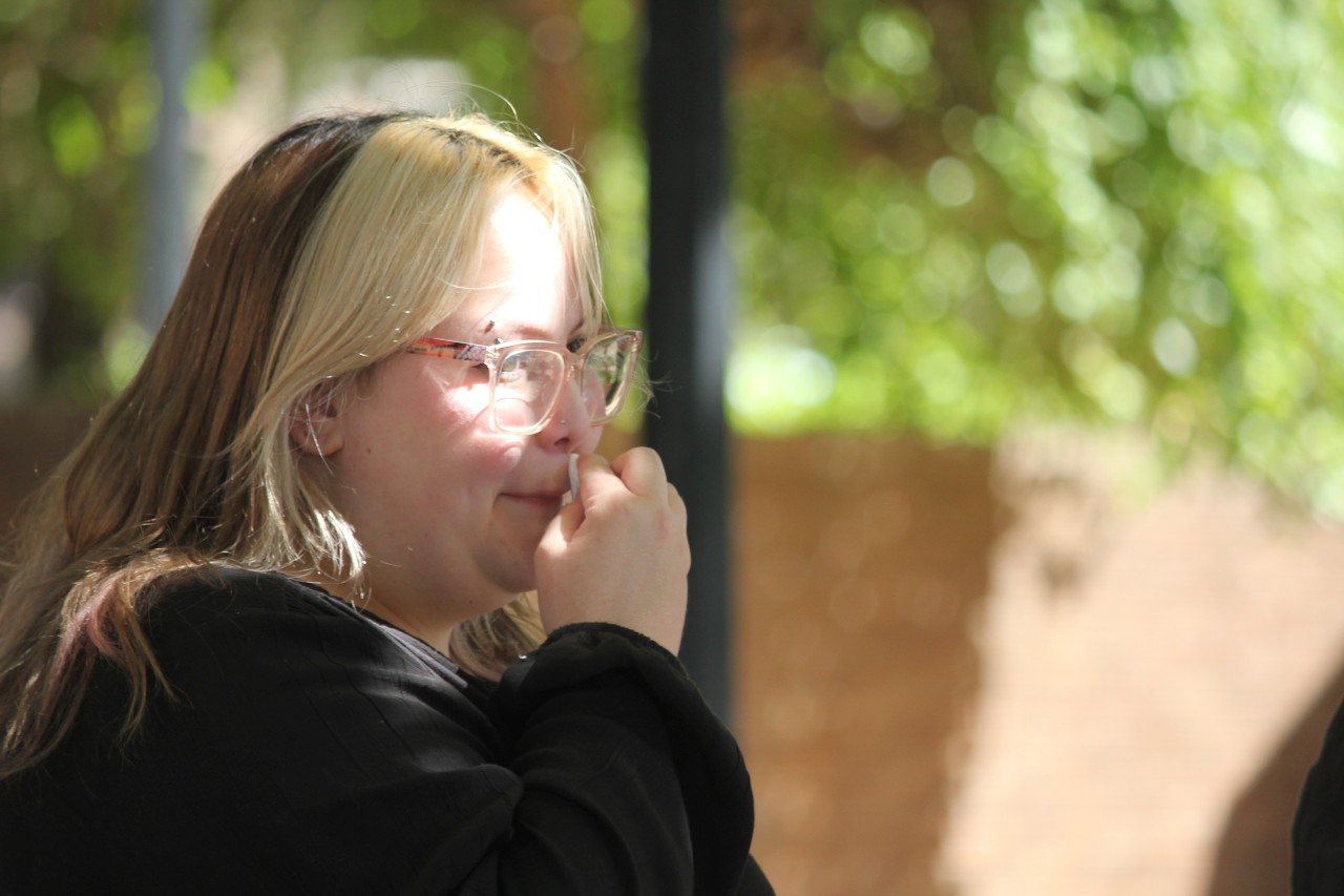 A close up of woman wiping face