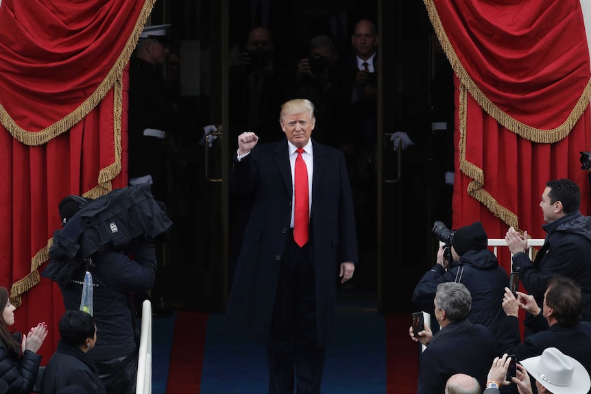 President-elect Donald Trump pumps his fist as he arrives for his Presidential Inauguration