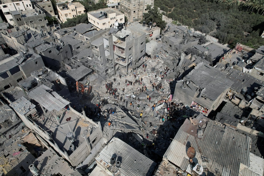 birds eye view shot of several buildings reduced to grey rubble