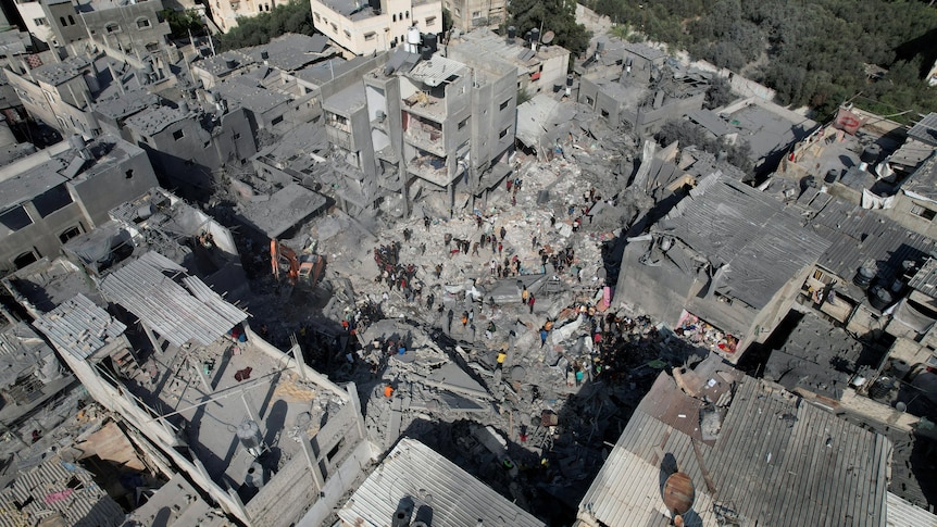 birds eye view shot of several buildings reduced to grey rubble