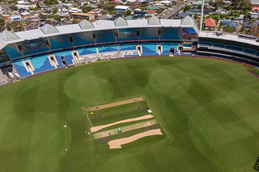 Cricket pitch undergoing maintenance as seen from above.