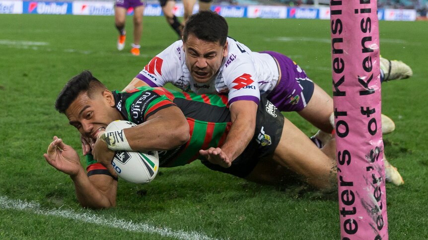 Hymel Hunt dives to score a try for the Rabbitohs in the corner against the Storm.
