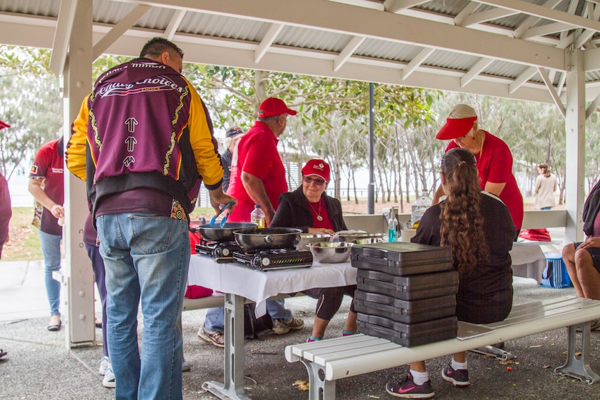 Team leaders cook a meal after walking.