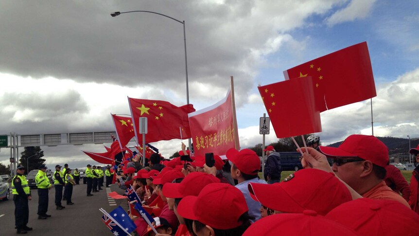 Supporters wave Chinese flags for President Xi Jinping in Hobart