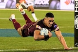 Valentine Holmes dives over to score a try for Queensland.