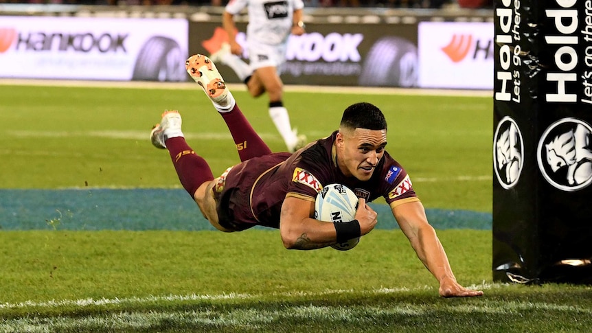 Valentine Holmes dives over to score