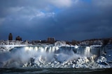 Water flows over the American Falls as ice forms in this view from the Canadian side in Niagara Falls.