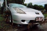 Flood debris covers a car damaged by floodwaters in Darra.