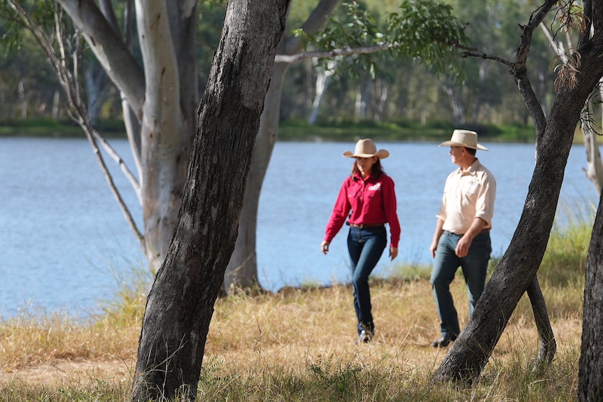 Michelle and Michael Lyons walking alongside a lagoon.
