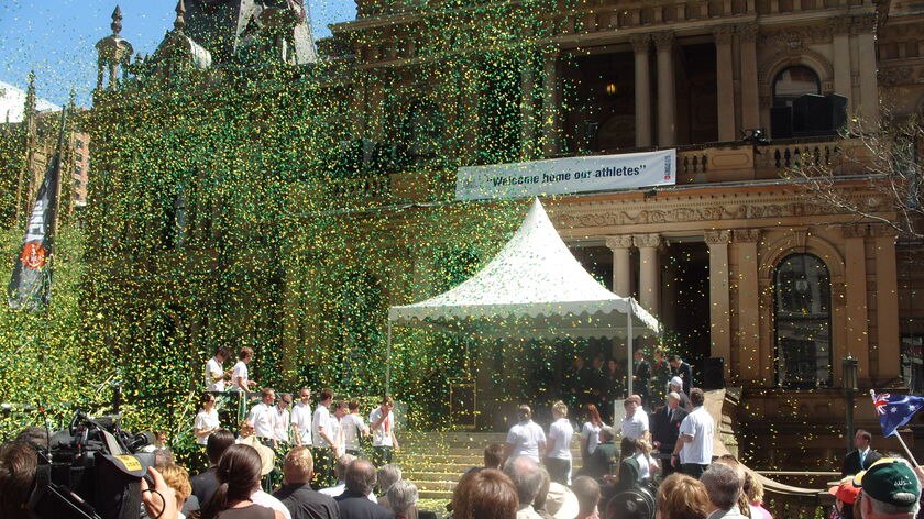 Celebration time: Green and gold confetti bursts from a canon at Sydney's Town Hall.