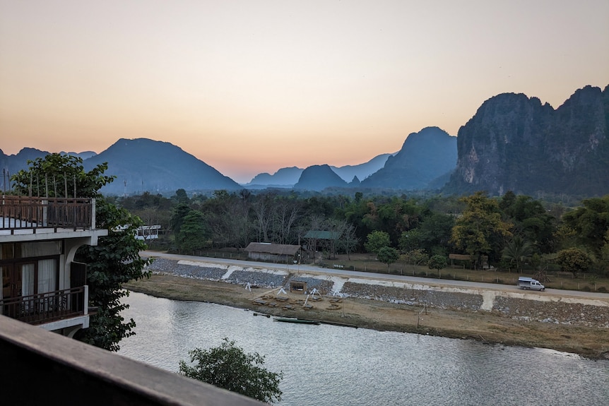 A river sits with hills in the background.