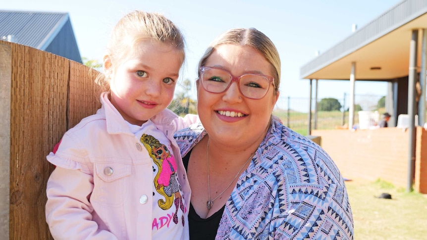 Georgia Leonard hugs her daughter Eva.