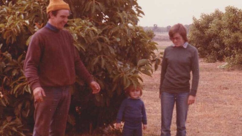 Little Katrina with her parents on their farm.