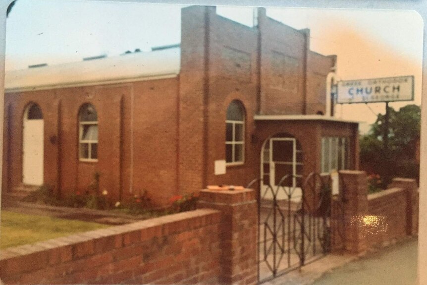 A red-brick building with a red-brick fence