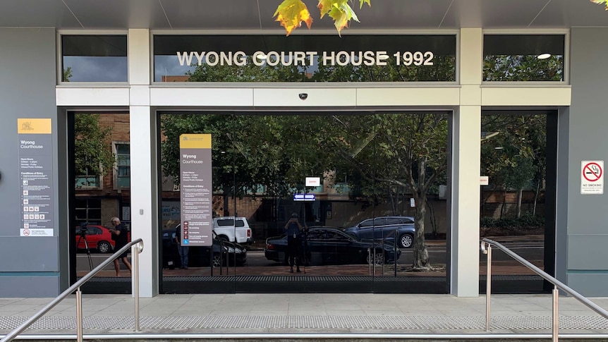Tinted glass doors and front steps of court building