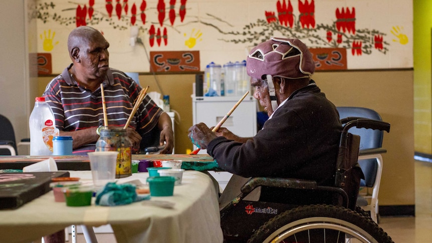 Ngaanyatjarra artist Neville Niypula Mcarthur painting in the Kungkarrangkalpa Aged Care facility in Wanarn.