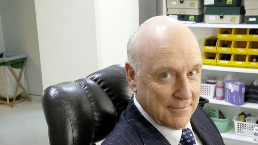 John Clarke sitting in a make up artist's chair at the ABC