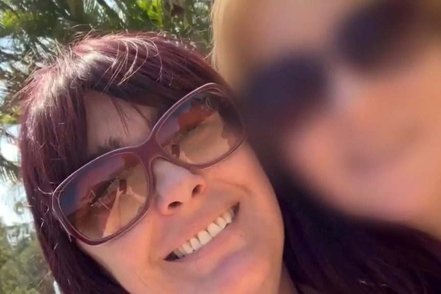 A selfie of two women, with the face of one blurred.
