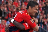 Adelaide's Marcelo Carrusca (L) celebrates his second goal against the Wellington Phoenix.