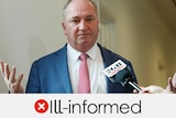 Barnaby Joyce, wearing a blue suit, with a picture frame saying "ill-informed"