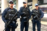Three special police holding long-arm guns.