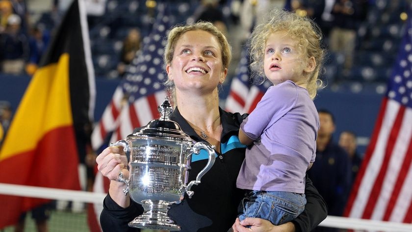 Kim Clijsters and daughter Jada pose with the championship trophy.