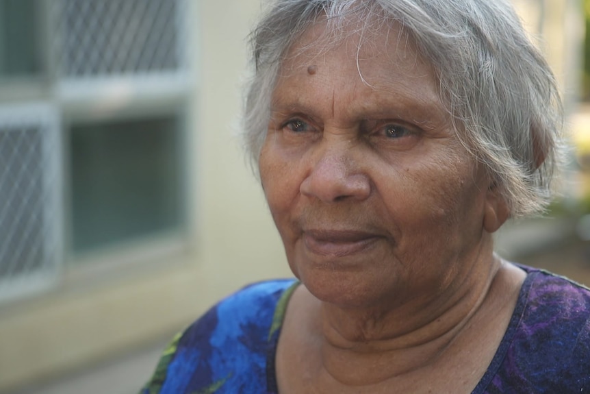 Elderly Aboriginal woman looking in the distance.