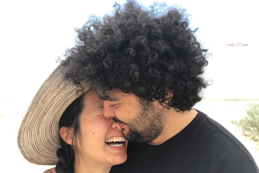 Jennifer Tran and John Kassab smile while in a close embrace