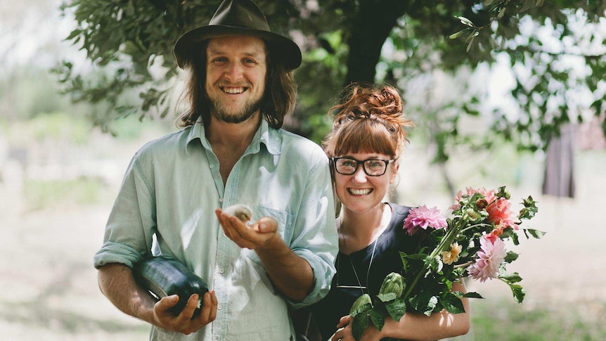 Matt and Lentil Purbrick with produce and fresh flowers