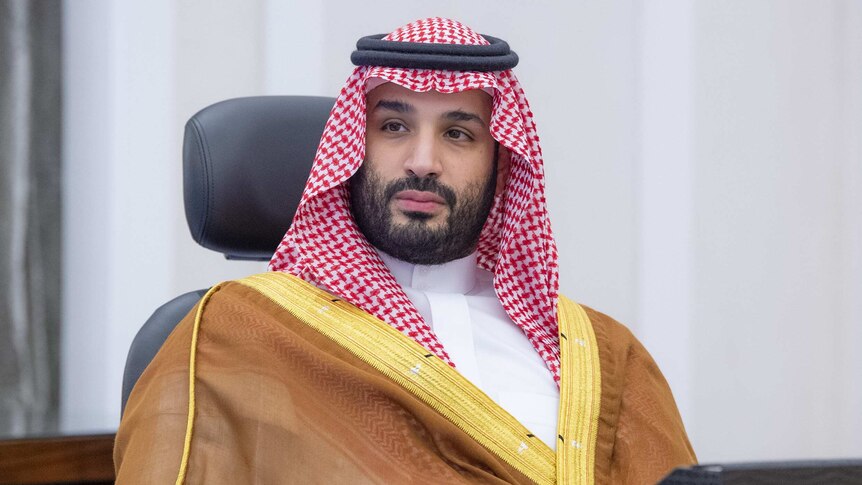 saudi crown prince mohammed bin salman sitting in chair looking into the distance