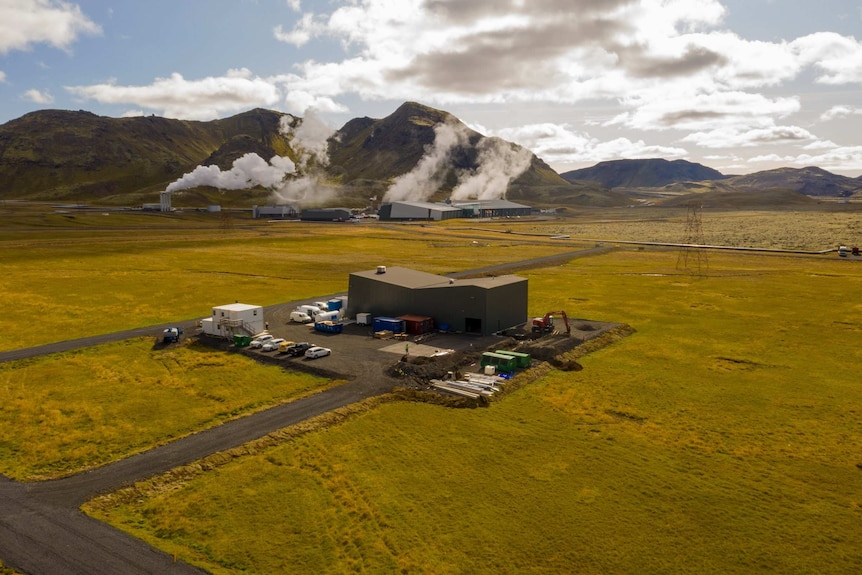 A steaming production plant against a green Icelandic countryside.