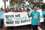 Belinda Teh and supporters with pro-euthanasia signs arrive at WA Parliament House.