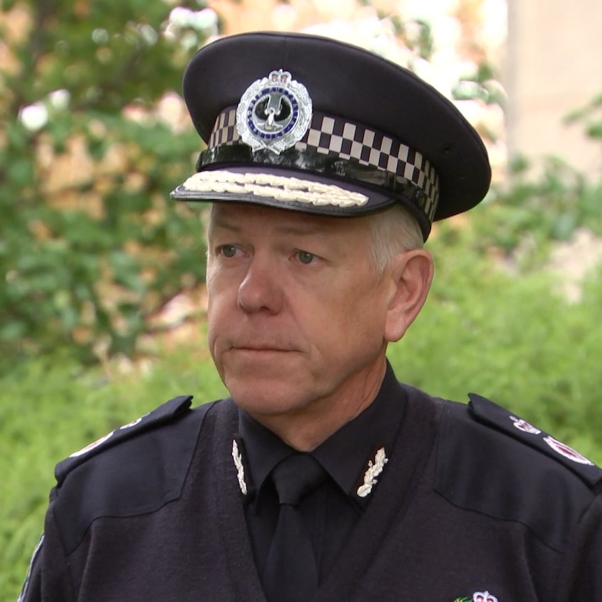 A man wearing a dark blue police uniform