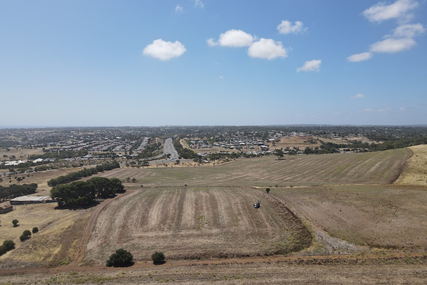 A large area of empty land, with blue skies above
