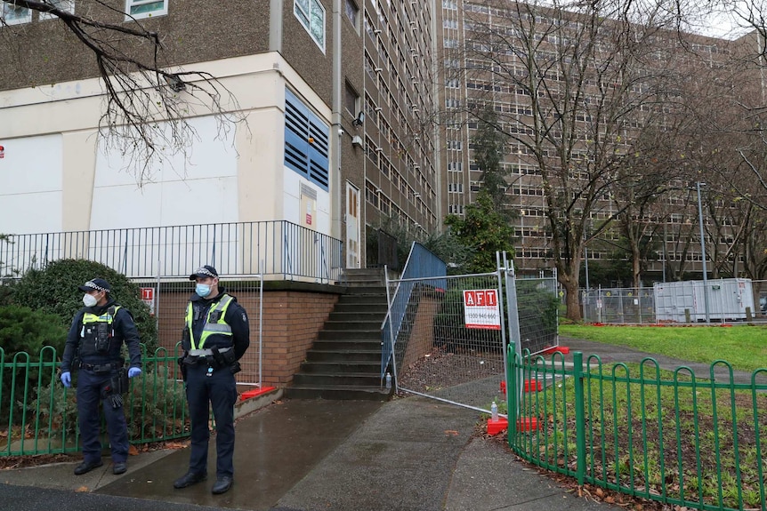 Police are seen outside the Alfred Street public housing tower.