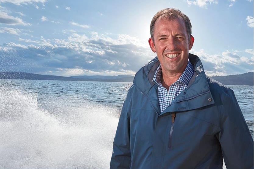 Tassal CEO and managing director Mark Ryan on a boat.