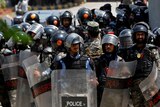 Pakistani police in riot gear stand outside the high court.