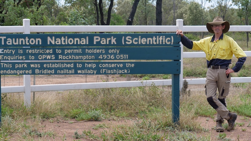 Alexander Dudley stands next to Taunton National Park sign
