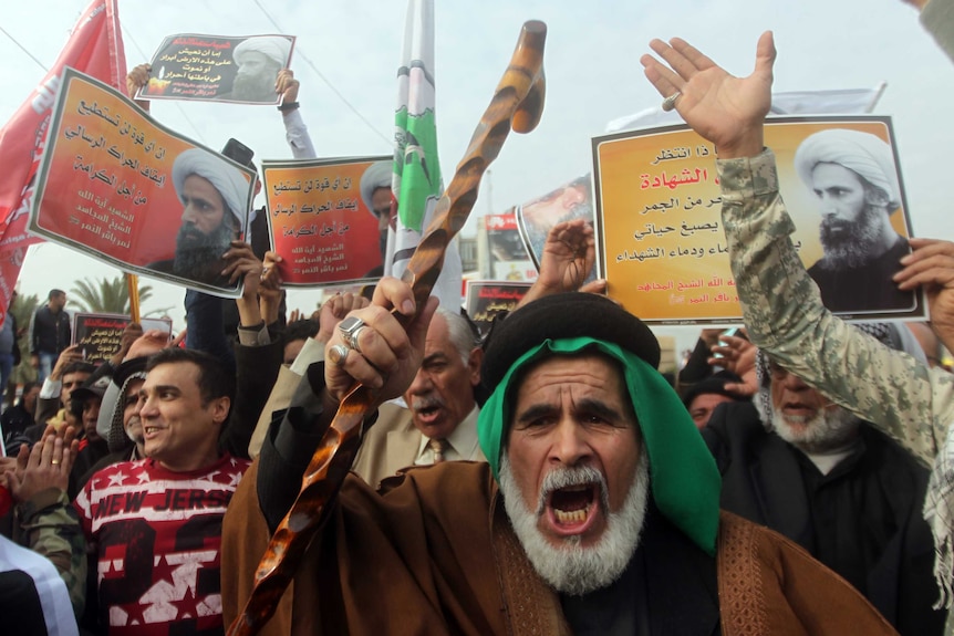 Angry protesters shouting in a crowd.