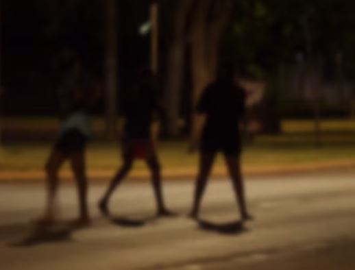 The silhouette of young people on the street at night