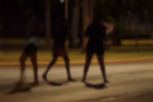 The silhouette of young people on the street at night