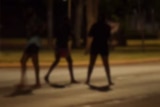 The silhouette of young people on the street at night
