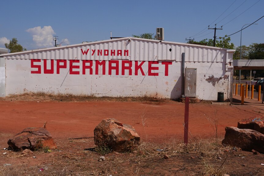A rundown rural supermarket with the words 'Wyndham Supermarket' on the side of the building