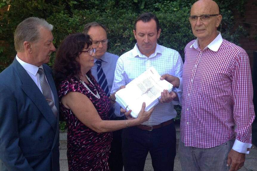 The parents of Hayley Dodd, Ray and Margaret (left), hand over a petition to Labor MPs including leader Mark McGowan.