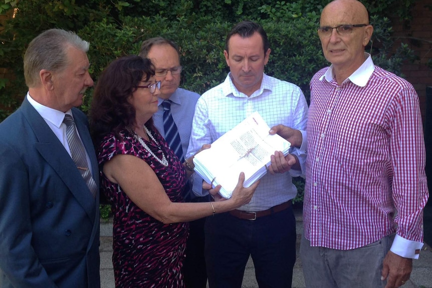 The parents of Hayley Dodd, Ray and Margaret (left), hand over a petition to Labor MPs including leader Mark McGowan.