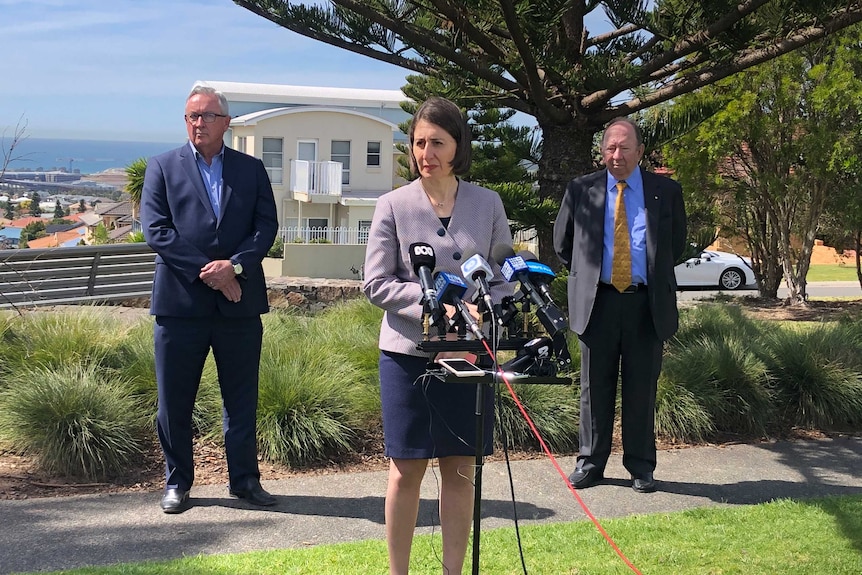 Premier Gladys Berejiklian speaking at a media conference in Shellharbour, with Brad Hazard and Dennis King behind