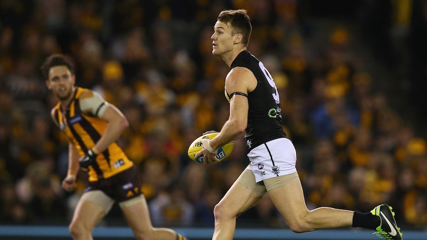 Robbie Gray looks to pass against Hawthorn
