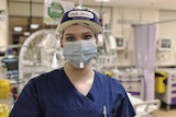 MCU of Courtnay Bisson, critical care nurse, wearing mask, visor and protective gown